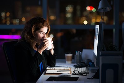 woman working on a computer at night